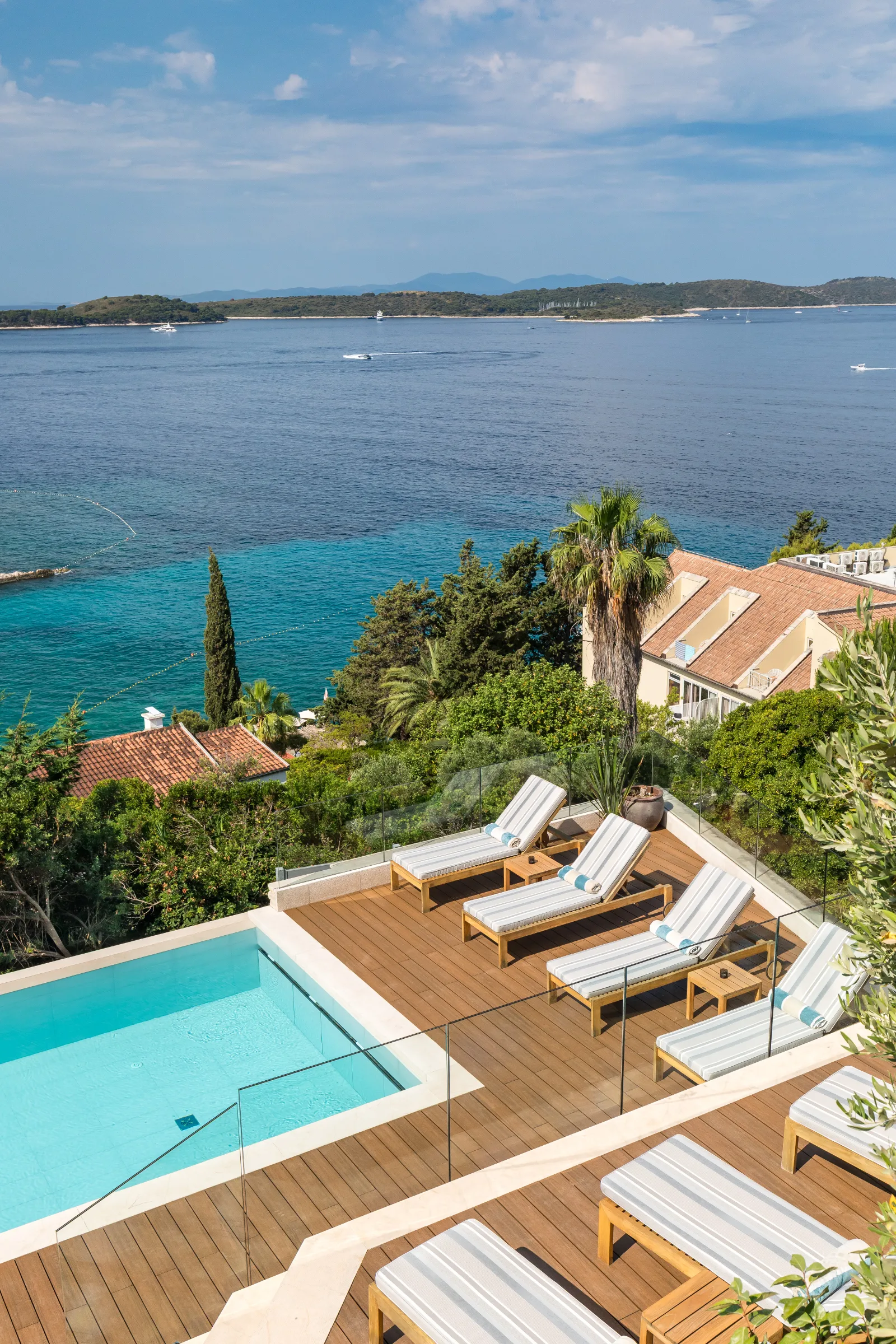 Pool terrace with sun loungers above the sea